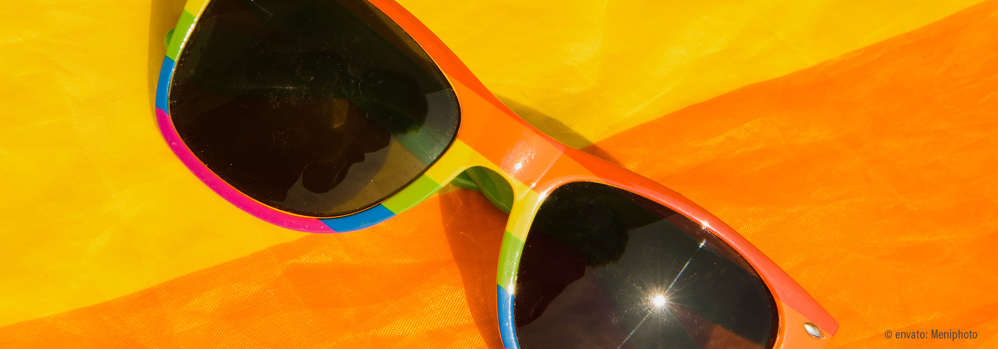 Bunte Sonnenbrille auf leuchtend gelbem Strandtuch - Ferienwoche Zeit für mich Lebenshilfe Alfeld